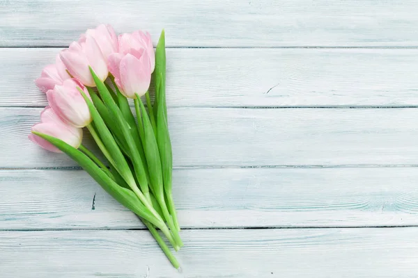 Pink tulips over wooden background — Stock Photo, Image