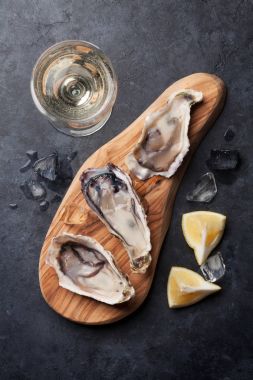 oysters on cutting board and white wine clipart