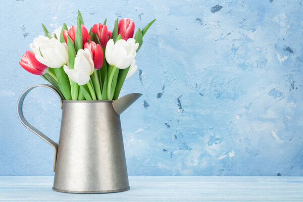 Colorful tulips in pitcher