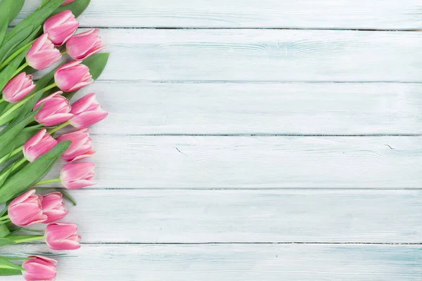 Pink tulips over wooden background — Stock Photo, Image