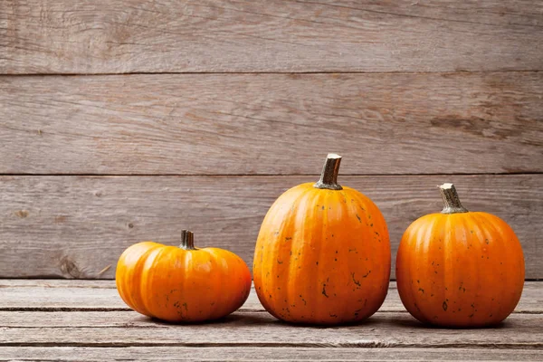 Autumn pumpkins on wooden table — Stock Photo, Image