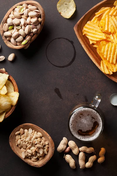 Lager beer and snacks on stone table — Stock Photo, Image