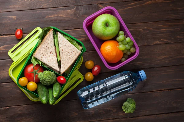Lunch box with vegetables and sandwich