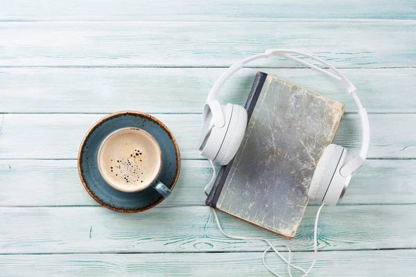 Headphones, coffee and book