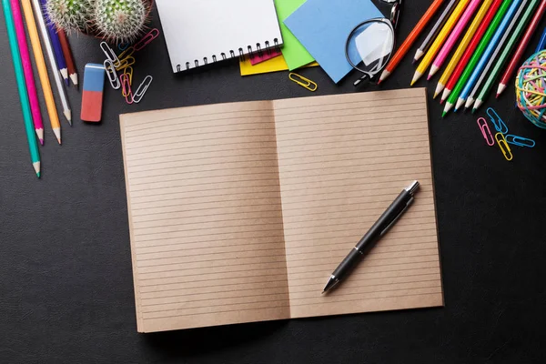 Desk with notepad and supplies — Stock Photo, Image