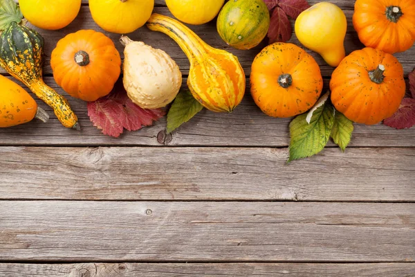 Autumn pumpkins on wooden table — Stock Photo, Image