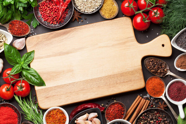 spices and herbs with cutting board