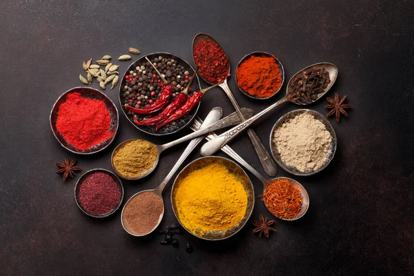 Spices and herbs in bowls and spoons — Stock Photo, Image