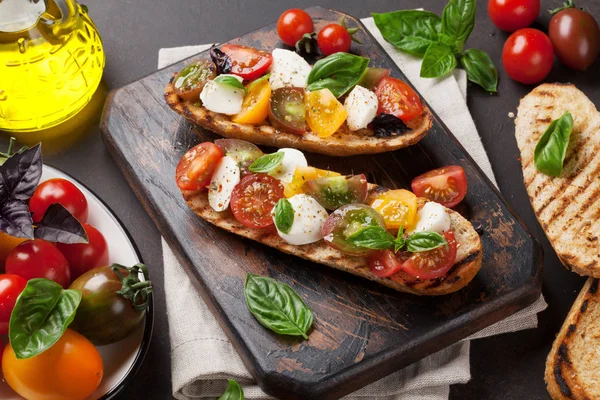 トマトとモッツァレラチーズとバジルのブルスケッタ — ストック写真