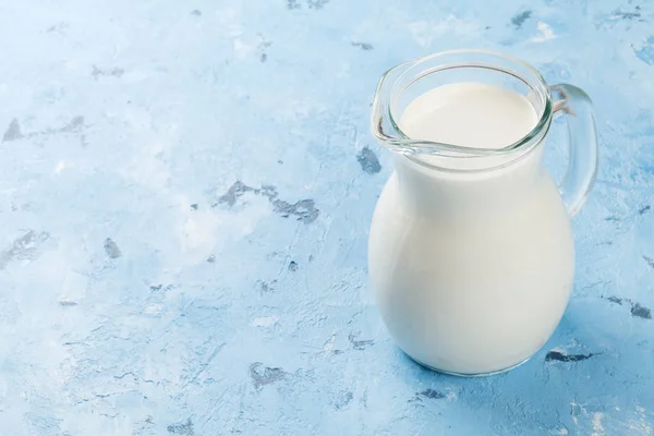 Milk jug on stone table — Stock Photo, Image