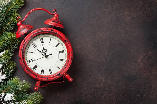 Snowy fir tree and alarm clock — Stock Photo, Image