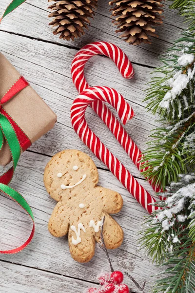 Gift, candy canes and gingerbread man — Stock Photo, Image
