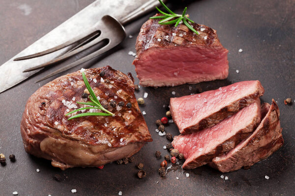 Grilled fillet steaks on stone table