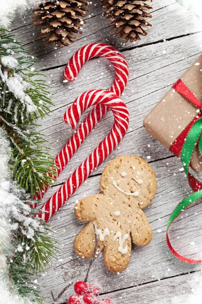 Christmas Presentbox Polkagrisar Pepparkakor Mannen Och Snöiga Granen Träbord Ovanifrån — Stockfoto