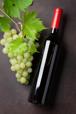 Şişe şarap ve üzüm taş masada. Üstten Görünüm