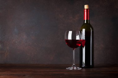 Kırmızı şarap şişe ve cam önünde tahta duvar. Kopya alanı ile