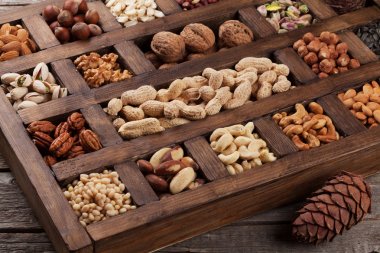 Çeşitli fındık seçim: fıstık, fındık, kestane, ceviz, Antep fıstığı ve pecans ahşap kutusunda