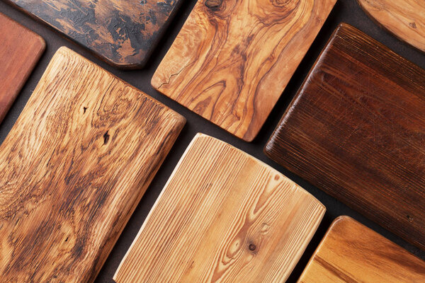 Various cutting boards on stone table. Cooking utensils. Top view