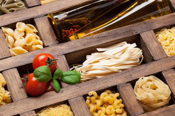 Various pasta in wooden box. Cooking concept