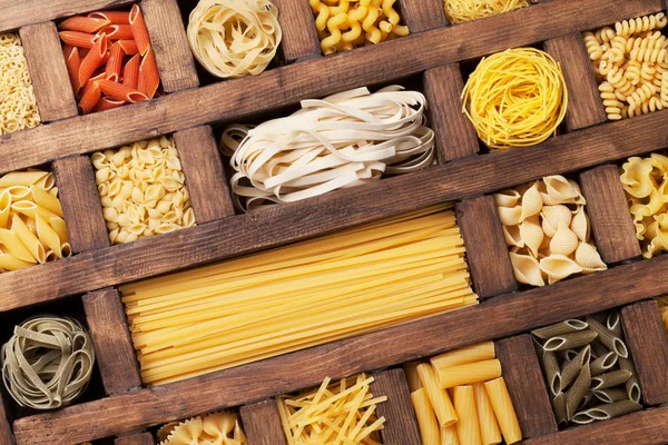 Various pasta in wooden box — Stock Photo, Image