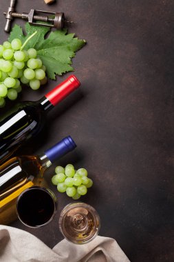 Şarap şişeleri ve üzüm taş masada. Metin alanı olan Üstten Görünüm