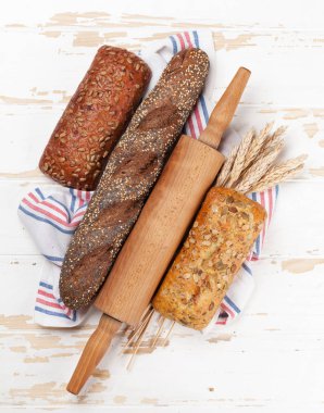 Çeşitli ekmek ve Beyaz ahşap zemin üzerine buns. Üstten Görünüm