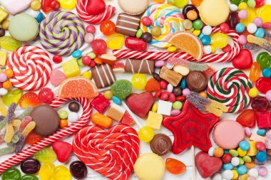 Colorful sweets. Lollipops and candies. Top view close up clipart