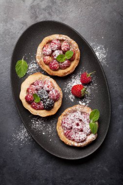Böğürtlenli tatlı kekler. Çilek, ahududu ve böğürtlen. Üst Manzara. Düz yatıyordu
