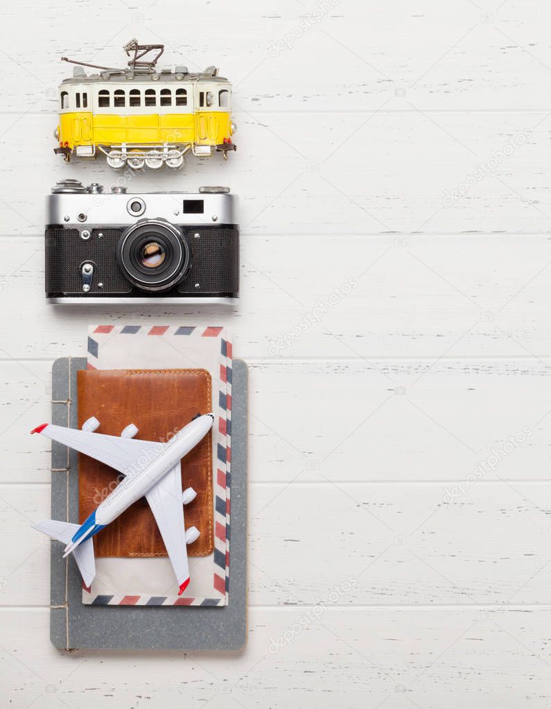 Travel concept backdrop with airplane, camera and passport. Top view flat lay with copy space