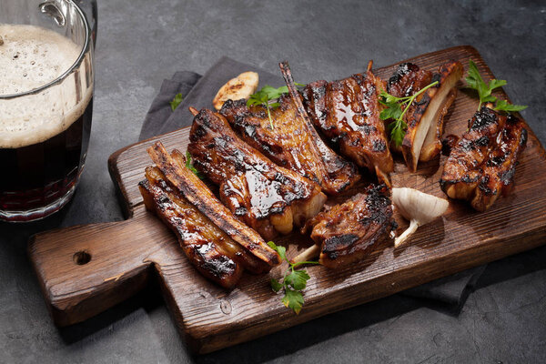 Barbecue beef ribs with bbq sauce sliced on a wooden board