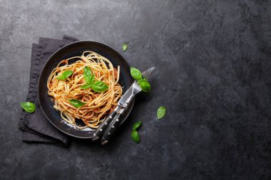 Domates ve kıyma sosu, parmesan peyniri ve taze fesleğen ile spagetti bolonez makarna. Kopyalama alanı ile üstte görünüm