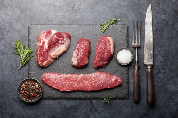 Variety Fresh Raw Beef Steaks Spices Stone Board Top View — Stock Photo, Image