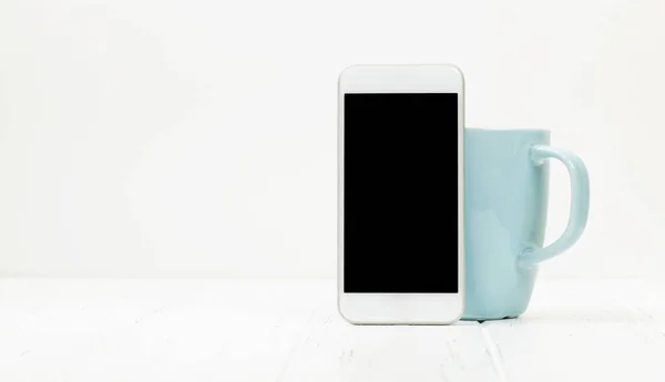 办公室桌子上有智能手机和咖啡杯 背景是白色的 为您的文字或应用程序留出空间 — 图库照片