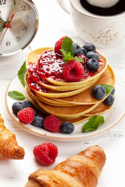 Delicious homemade pancakes with summer berries and coffee. Time for breakfast