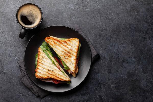 Club sandwich and coffee cup. Breakfast meal. Top view with copy space