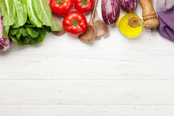 Cooking utensils and ingredients on wooden background. Top view with copy space for your recipe. Flat lay