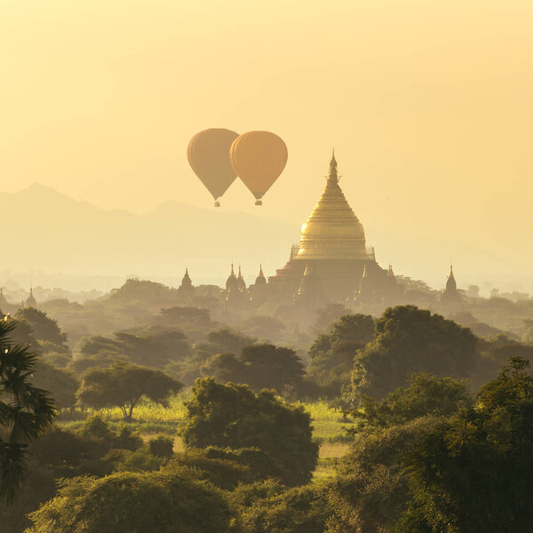 Air balloons over Buddhist temples at sunrise