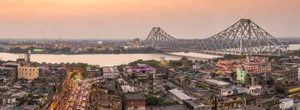 Howrah bridge - The historic cantilever bridge on the river Hooghly with a sunset sky in Kolkata, India. Top view, big panorama shot.