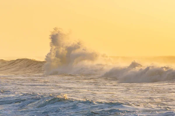 Big stormy waves crashing over Portuguese coast during sunset