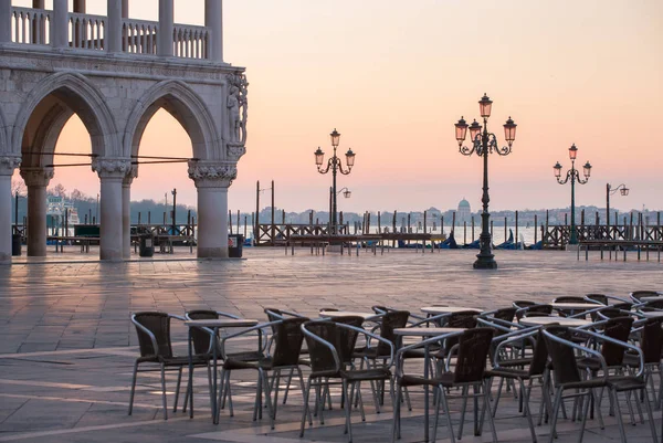 Outdoor cafe near the Palace of doges on the San Marco square at the sunrise in Venice, Italy