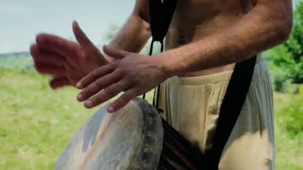 Oidentifierad kaukasisk man spelar afrikansk djembe trumma — Stockvideo