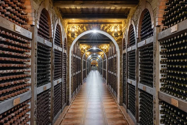 Bottiglie di vino impilate in cantina sotterranea — Foto Stock