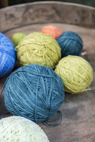 Balls of yarn for knitting in a wooden tray. — Stock Photo, Image