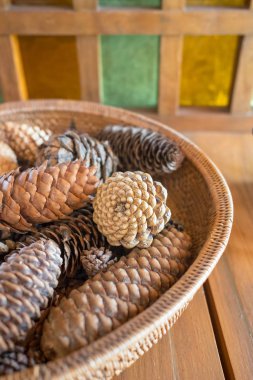 Rattan basket with pine cones close up
