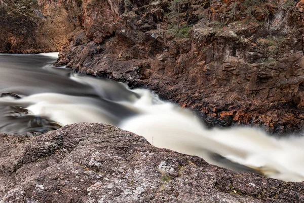 Long exposure of rapid mountain river flowing through the rocks — Stock Photo, Image