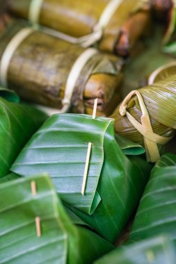 Glutinous rice steamed in banana leaf Khao Tom Mat or Khao Tom Pad food background