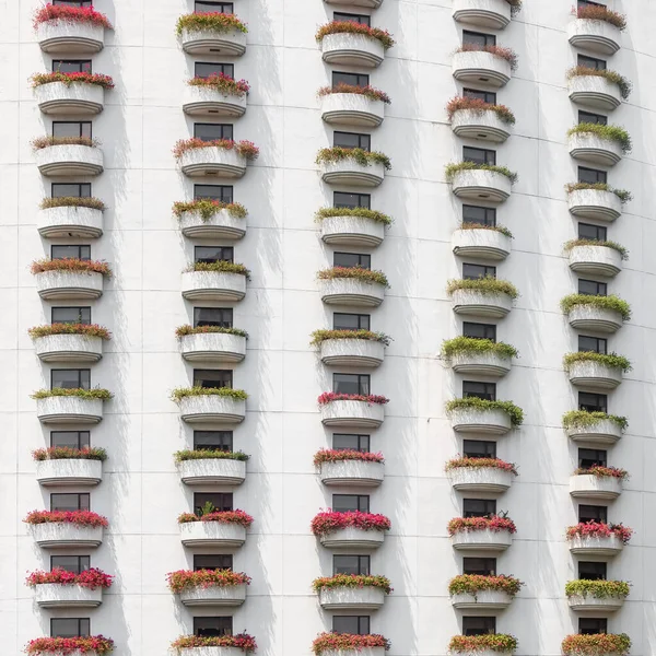 Residential building with balconies covered with flowers — Stock Photo, Image