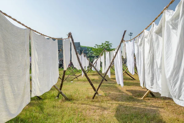 Laundry drying on a rope in the yard in the sunlight
