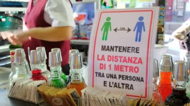 Karantina duyurusu İtalya 'daki kafedeki insanlar arasında yaklaşık bir metre uzaklıkta.