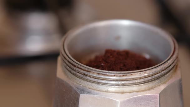 Putting coffee powder in the moka pot with the spoon — Stock Video